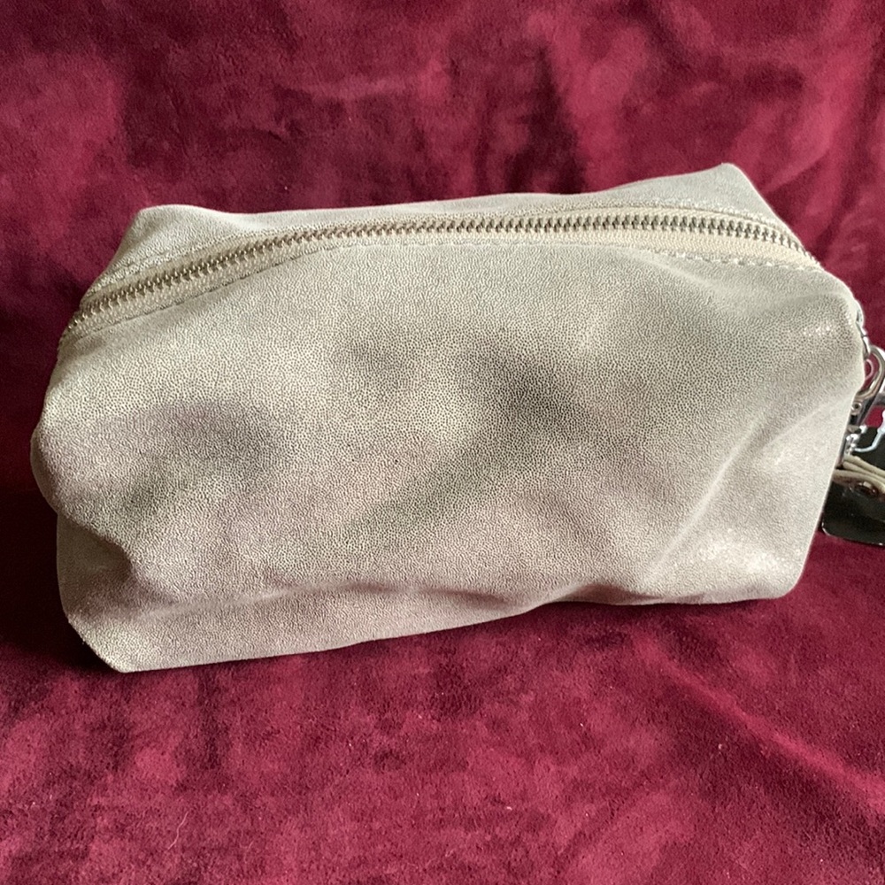 Metallic leather bag , with wrist strap